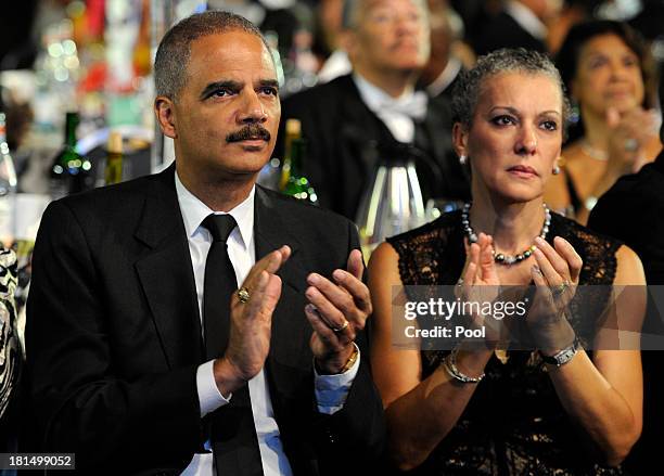 Attorney General Eric Holder applauds along with his wife Dr. Sharon Malone as they await the arrival of President Barack Obama at the Congressional...