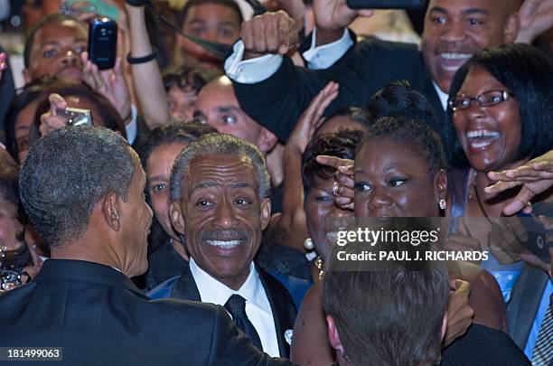 President Barack Obama greets Rev. Al Sharpton , Trayvon Martin's mother Sybrina Fulton , and others in the crowd after delivering remarks at the...