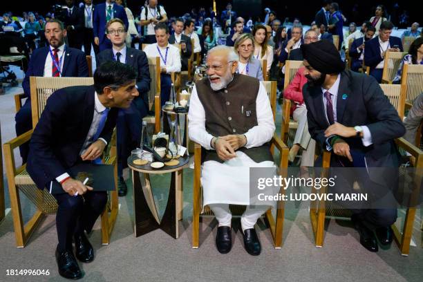 India Prime Minister Narendra Modi and British Prime Minister Rishi Sunak listen to World Bank President Ajay Banga during the Transforming Climate...