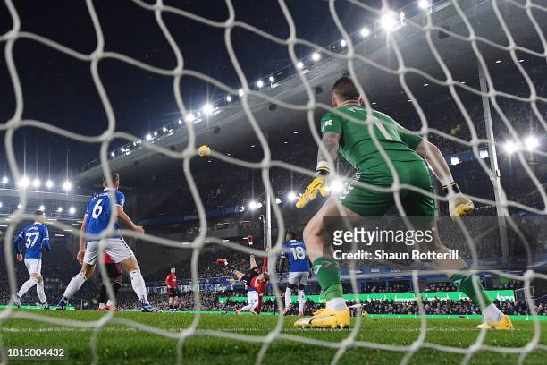 Jordan Pickford of Everton fails to save as Alejandro Garnacho of Manchester United scores the team's first goal during the Premier League match...