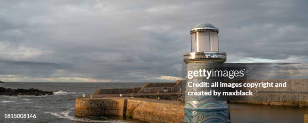 model lighthouse on the harbours edge-portsoy - portsoy stock pictures, royalty-free photos & images