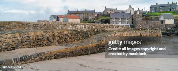 quay at portsoy harbour-scotland. - moray scotland stock pictures, royalty-free photos & images