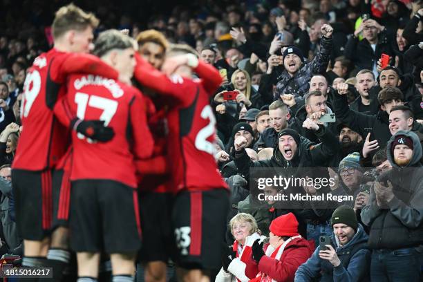 Fans of Manchester United celebrate as Marcus Rashford of Manchester United scores the team's second goal from the penalty spot during the Premier...