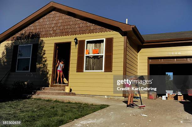 Twin sisters Abby, left, and Gabby Ramirez, right, age 10, helped clean out the flooded home of their uncle Horacio Perches in Evans Saturday....