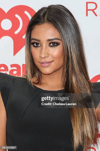 Actress Shay Mitchell poses in the iHeartRadio music festival photo room on September 21, 2013 in Las Vegas, Nevada.