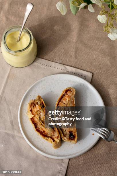 strudel cake and  vanilla sauce - strudel stock pictures, royalty-free photos & images