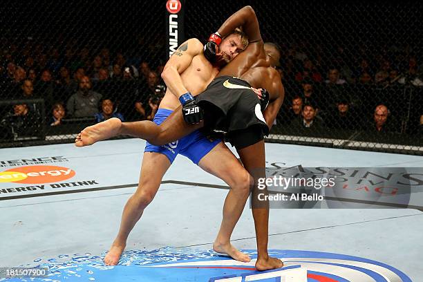 Alexander Gustafsson attempts a takedown on Jon Jones in their UFC light heavyweight championship bout at the Air Canada Center on September 21, 2013...