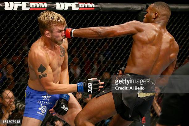 Jon Jones punches Alexander Gustafsson in their UFC light heavyweight championship bout at the Air Canada Center on September 21, 2013 in Toronto,...