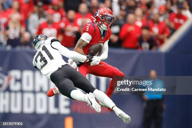 Tank Dell of the Houston Texans catches a pass in front of Darious Williams of the Jacksonville Jaguars during the first quarter at NRG Stadium on...