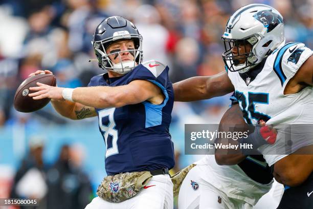 Will Levis of the Tennessee Titans attempts a pass while pressured by Derrick Brown of the Carolina Panthers during the first quarter at Nissan...