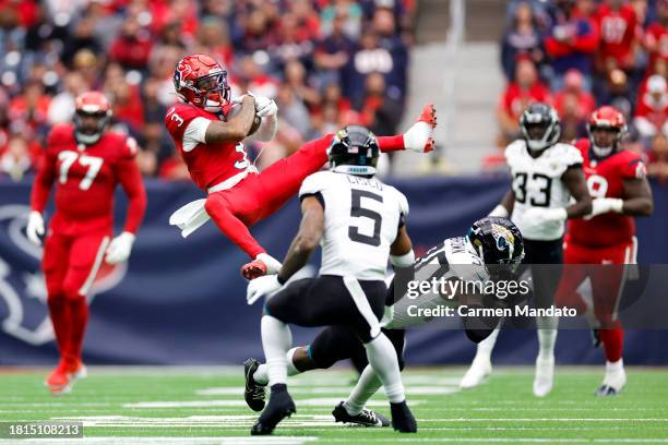 Tank Dell of the Houston Texans catches a pass in front of Montaric Brown and Andre Cisco of the Jacksonville Jaguars during the second quarter at...