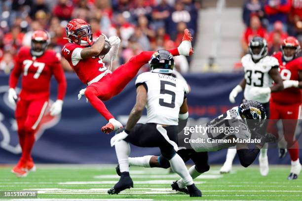 Tank Dell of the Houston Texans catches a pass in front of Montaric Brown and Andre Cisco of the Jacksonville Jaguars during the second quarter at...