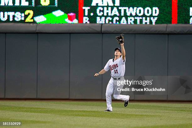 September 13: Clete Thomas of the Minnesota Twins fields a ball hit by the Tampa Bay Rays on September 13, 2013 at Target Field in Minneapolis,...