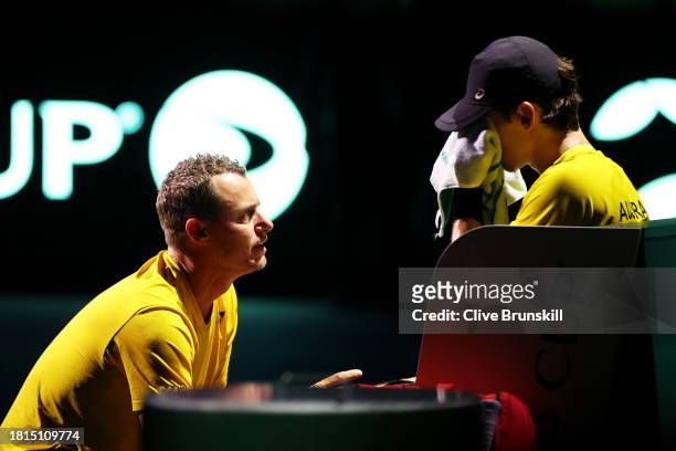 Lleyton Hewitt speaks to Alex De Minaur of Australia during the Davis Cup Final match against Italy at Palacio de Deportes Jose Maria Martin Carpena...