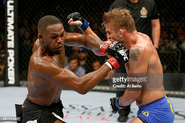 Jon 'Bones' Jones punches Alexander Gustafsson in their UFC light heavyweight championship bout at the Air Canada Center on September 21, 2013 in...