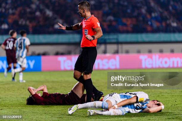 Franco Mastantuono of Argentina lies injured after been challenged by Pablo Ibarra of Venezuela during FIFA U-17 World Cup Round of 16 match between...