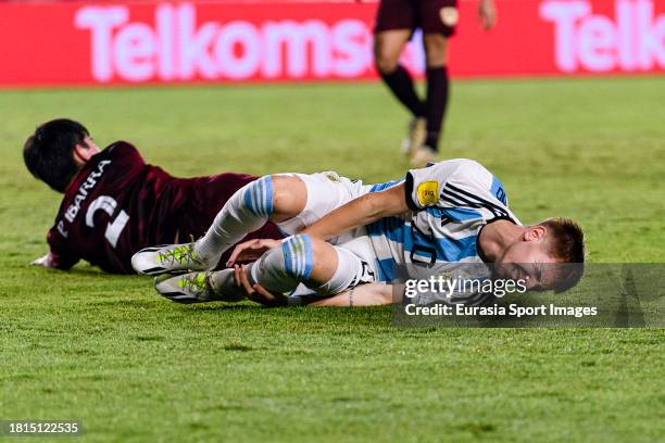 Franco Mastantuono of Argentina lies injured after been challenged by Pablo Ibarra of Venezuela during FIFA U-17 World Cup Round of 16 match between...