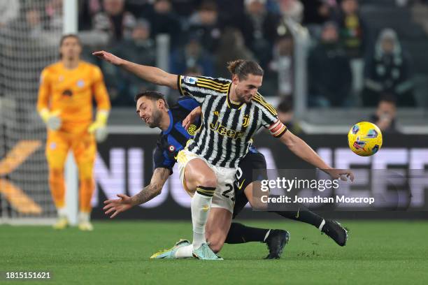 Hakan Calhanoglu of FC Internazionale clashes with Adrien Rabiot of Juventus during the Serie A TIM match between Juventus and FC Internazionale at...