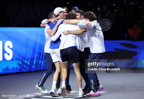 Jannik Sinner of Italy celebrates with teammates after winning match point during the Davis Cup Final match against Alex De Minaur of Australia at...