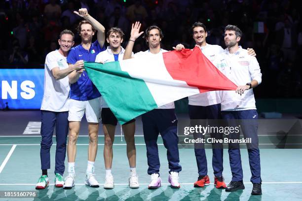 Jannik Sinner of Italy celebrates with teammates after winning match point during the Davis Cup Final match against Alex De Minaur of Australia at...