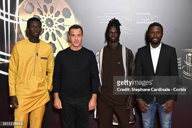 Seydou Sarr, Matteo Garrone, Moustapha Fall and Mamadou Kouassi attend "Me Captain" Premiere during the 20th Marrakech International Film Festival on...