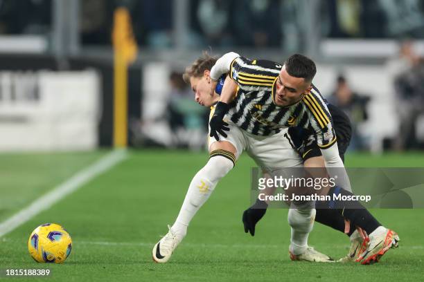 Filip Kostic of Juventus clashes with Nicolo Barella of FC Internazionale during the Serie A TIM match between Juventus and FC Internazionale at on...