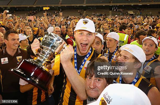 Luke Lowden of the Hawks celebrates with the Premiership Cup after winning the VFL Grand Final match between the Box Hill Hawks and the Geelong Cats...