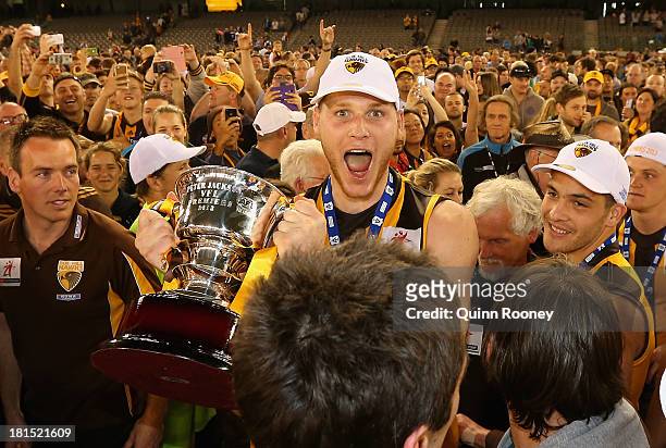 Luke Lowden of the Hawks celebrates with the Premiership Cup after winning the VFL Grand Final match between the Box Hill Hawks and the Geelong Cats...