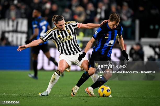 Adrien Rabiot of Juventus is challenged by Nicolo Barella of FC Internazionale during the Serie A TIM match between Juventus and FC Internazionale at...