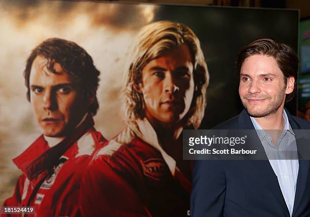 Actor Daniel Bruehl looks on next to a poster for the movie as he arrives at the Australian premiere of "Rush" at Village Cinemas on September 22,...