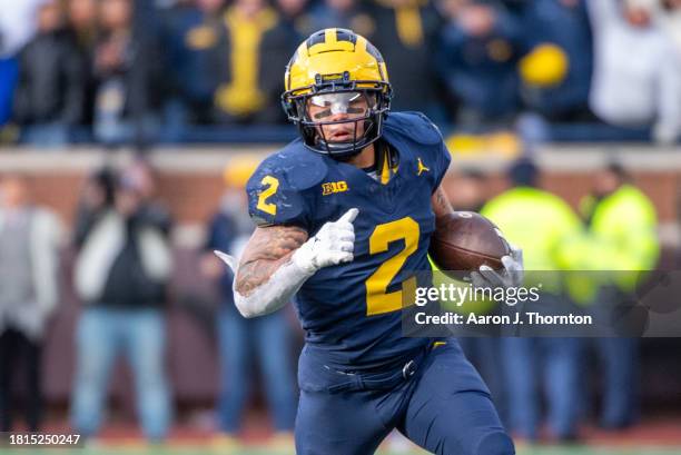 Blake Corum of the Michigan Wolverines runs with the ball for yardage during the second half of a college football game against the Ohio State...