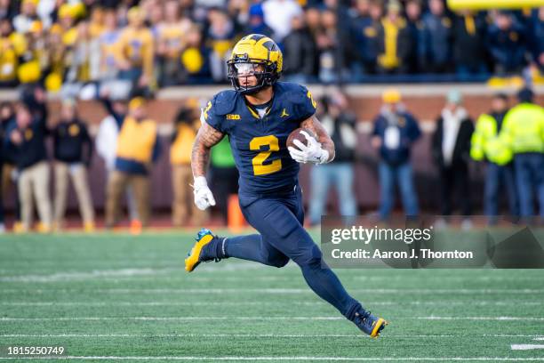 Blake Corum of the Michigan Wolverines runs with the ball for yardage during the second half of a college football game against the Ohio State...