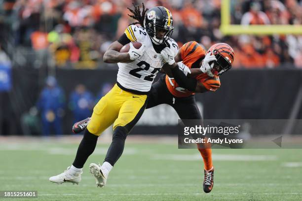 Najee Harris of the Pittsburgh Steelers carries the ball past Chidobe Awuzie of the Cincinnati Bengals during the second half of the game at Paycor...