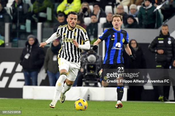 Filip Kostic of Juventus is challenged by Nicolo Barella of FC Internazionale during the Serie A TIM match between Juventus and FC Internazionale at...