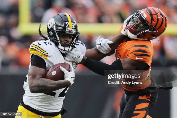 Najee Harris of the Pittsburgh Steelers carries the ball past Chidobe Awuzie of the Cincinnati Bengals during the second half of the game at Paycor...