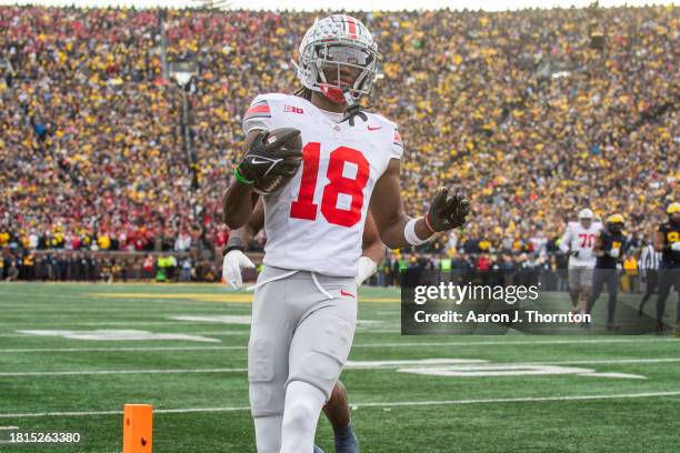 Marvin Harrison Jr. #18 of the Ohio State Buckeyes runs with the ball for a touchdown during the second half of a college football game against the...