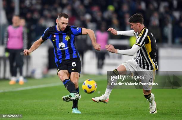 Stefan de Vrij of FC Internazionale passes the ball whilst under pressure from Dusan Vlahovic of Juventus during the Serie A TIM match between...