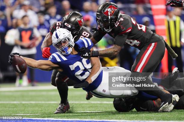 Jonathan Taylor of the Indianapolis Colts reaches with the ball for a first down in the fourth quarter of the game against the Tampa Bay Buccaneers...