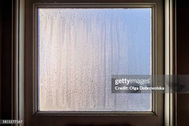 full frame of water droplets sliding on a window pane - humidity stock pictures, royalty-free photos & images