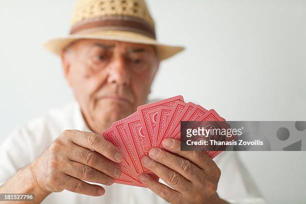 senior man playing cards - senior men playing cards stock pictures, royalty-free photos & images
