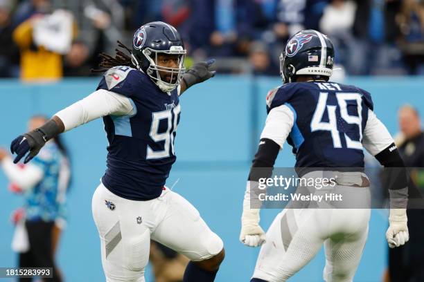 Denico Autry and Arden Key of the Tennessee Titans celebrate a sack during the second half of the game against the Carolina Panthers at Nissan...