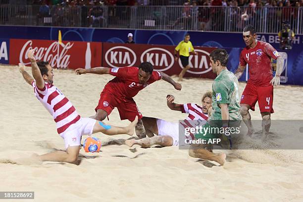 Tahiti's Patrick Tepa fights for the ball with United States' Lewie Valentine and Nicolas Perera before US goalkeeper Christopher Toth on September...