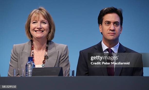 Labour party leader Ed Miliband sits next to deputy party leader Harriet Harman at the Labour Party conference on September 22, 2013 in Brighton,...