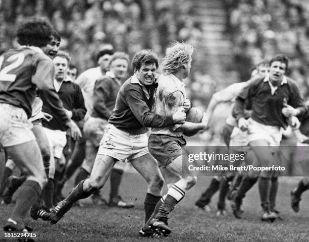 Jean-Pierre Rives of France is tackled by Fergus Slattery of Ireland during a Five Nations Championship match at Lansdowne Road on February 19, 1983...