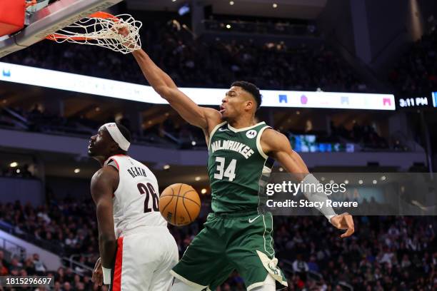 Giannis Antetokounmpo of the Milwaukee Bucks dunks over Duop Reath of the Portland Trail Blazers during the first half of a game at Fiserv Forum on...