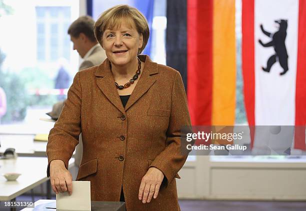 Angela Merkel, German Chancellor and Chairwoman of the German Christian Democrats , casts her ballot in German federal elections on September 22,...