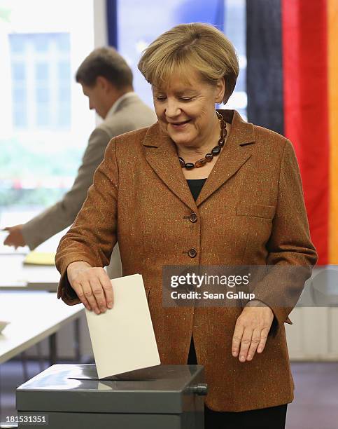 Angela Merkel, German Chancellor and Chairwoman of the German Christian Democrats , casts her ballot with her husband Joachim Sauer in German federal...