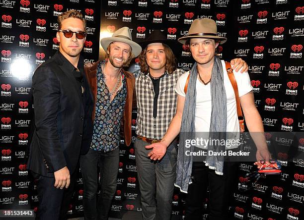 Singers Isaac Hanson, Paul McDonald, Zac Hanson and Taylor Hanson arrive at the iHeartRadio Music Festival official closing party at the Light...