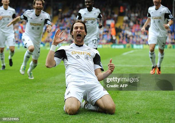 Swansea City's Spanish midfielder Miguel Michu celebrates scoring his team's first goal during the English Premier League football match between...