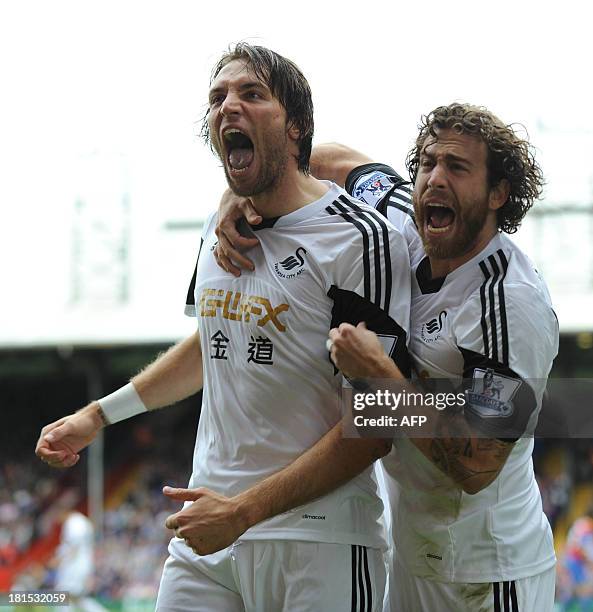 Swansea City's Spanish midfielder Miguel Michu celebrates scoring his team's first goal during the English Premier League football match between...